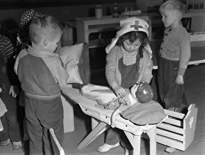 DAYCARE, 1943. Catherine Simmons playing Red Cross nurse at the Bella Vista Nursery DAYCARE, 1943. Catherine Simmons playing Red Cross nurse at the Bella Vista Nursery