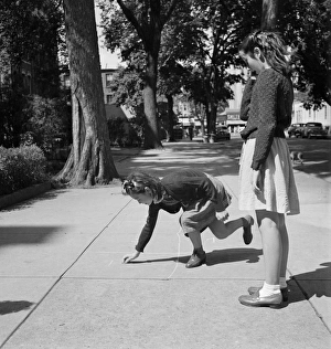 HOPSCOTCH, 1942. A Chinese-American girl playing hopscotch with her Jewish friend HOPSCOTCH, 1942. A Chinese-American girl playing hopscotch with her Jewish friend