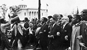 MARTIN LUTHER KING, JR. (1929-1968). American clergyman and reformer. Dr. King (fourth from right) leading the march from Selma on the state capitol at Montgomery, Alabama, 25 March 1965 MARTIN LUTHER KING, JR. (1929-1968). American clergyman and reformer. Dr. King (fourth from right) leading the march from Selma on the state capitol at Montgomery, Alabama, 25 March 1965