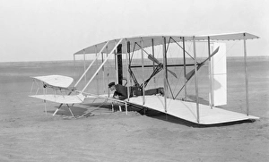 Wilbur Wright in prone position in damaged glider after unsuccessful trial, Kitty Hawk Wilbur Wright in prone position in damaged glider after unsuccessful trial, Kitty Hawk