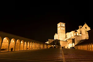 Arches along Piazza San Francesco at night with Basilica of San Francesco d'Assisi in the background Arches along Piazza San Francesco at night with Basilica of San Francesco d'Assisi in the background