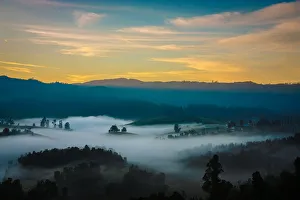 <b class=qtipBold><figcaption>Painted Landscape of Nilgiris</figcaption></b><br>One of those beautiful mornings where the earth is cozily sleeping under a blanket of fog and the first light from behind the mountains gently wakes her up by removing the blanket cover.Taken somewhere between Kodaikanal and Munnar. Painted Landscape of Nilgiris