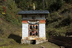 Small shelter for a Buddhist prayer wheel at the entrance to Dochula Pass, Bhutan Small shelter for a Buddhist prayer wheel at the entrance to Dochula Pass, Bhutan