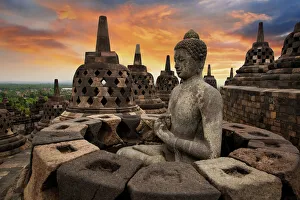 Sunrise with a Buddha Statue with the Hand Position of Dharmachakra Mudra in Borobudur Sunrise with a Buddha Statue with the Hand Position of Dharmachakra Mudra in Borobudur