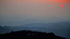 <b class=qtipBold><figcaption>Sunrise above the hill</figcaption></b><br>Sun rises just above the hills of Western Ghats, India. The layers of hills create a surreal feeling. Sunrise above the hill