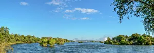 Zambezi River view with the spray from Victoria Falls in the distance. Livingstone. Zambia Zambezi River view with the spray from Victoria Falls in the distance. Livingstone. Zambia