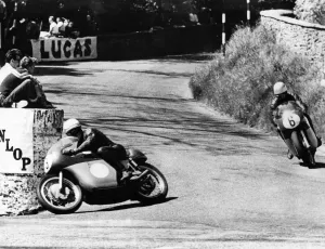 Mike Hailwood leads Rhodesia's Gary Hocking as they go into the last lap in the Junior Mike Hailwood leads Rhodesia's Gary Hocking as they go into the last lap in the Junior