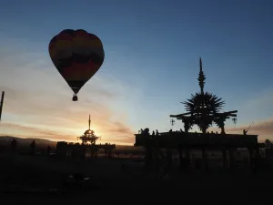 Hot air balloon flies over the Solar Temple at dawn at the Symbiosis Oregon Eclipse Hot air balloon flies over the Solar Temple at dawn at the Symbiosis Oregon Eclipse