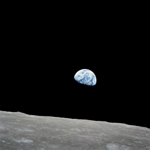 <b class=qtipBold><figcaption>Earth rising above the lunar horizon</figcaption></b><br>December 24, 1968 - The rising Earth is about five degrees above the lunar horizon in this telephoto view taken from the Apollo 8 spacecraft near 110 degrees east longitude. The horizon, about 570 kilometers (350 statute miles) from the spacecraft, is near the eastern limb of the moon as viewed from Earth. Width of the view at the horizon is about 150 kilometers (95 statute miles). On Earth 240, 000 statute miles away the sunset terminator crosses Africa. The South Pole is in the white area near the left end of the terminator. North and South America are under the clouds.<br><em>© Stocktrek Images</em> Earth rising above the lunar horizon