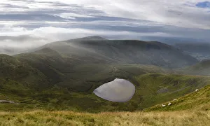 Vew of Llyn Lluncaws taken from Moel Sych in the Berwyn Mountains, Powys, Wales, UK August Vew of Llyn Lluncaws taken from Moel Sych in the Berwyn Mountains, Powys, Wales, UK August