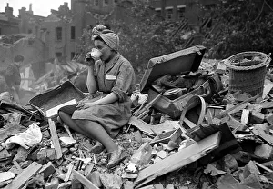 A woman enjoys a cup of tea in the midst of the bomb damage at New Cross after air raids A woman enjoys a cup of tea in the midst of the bomb damage at New Cross after air raids